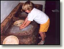 Ciska grinding corn in the Anasazi Heritage Center