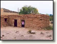 Ciska in the doorway of a reconstructed Anasazi home